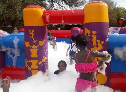 Children playing in a colourful foam pit